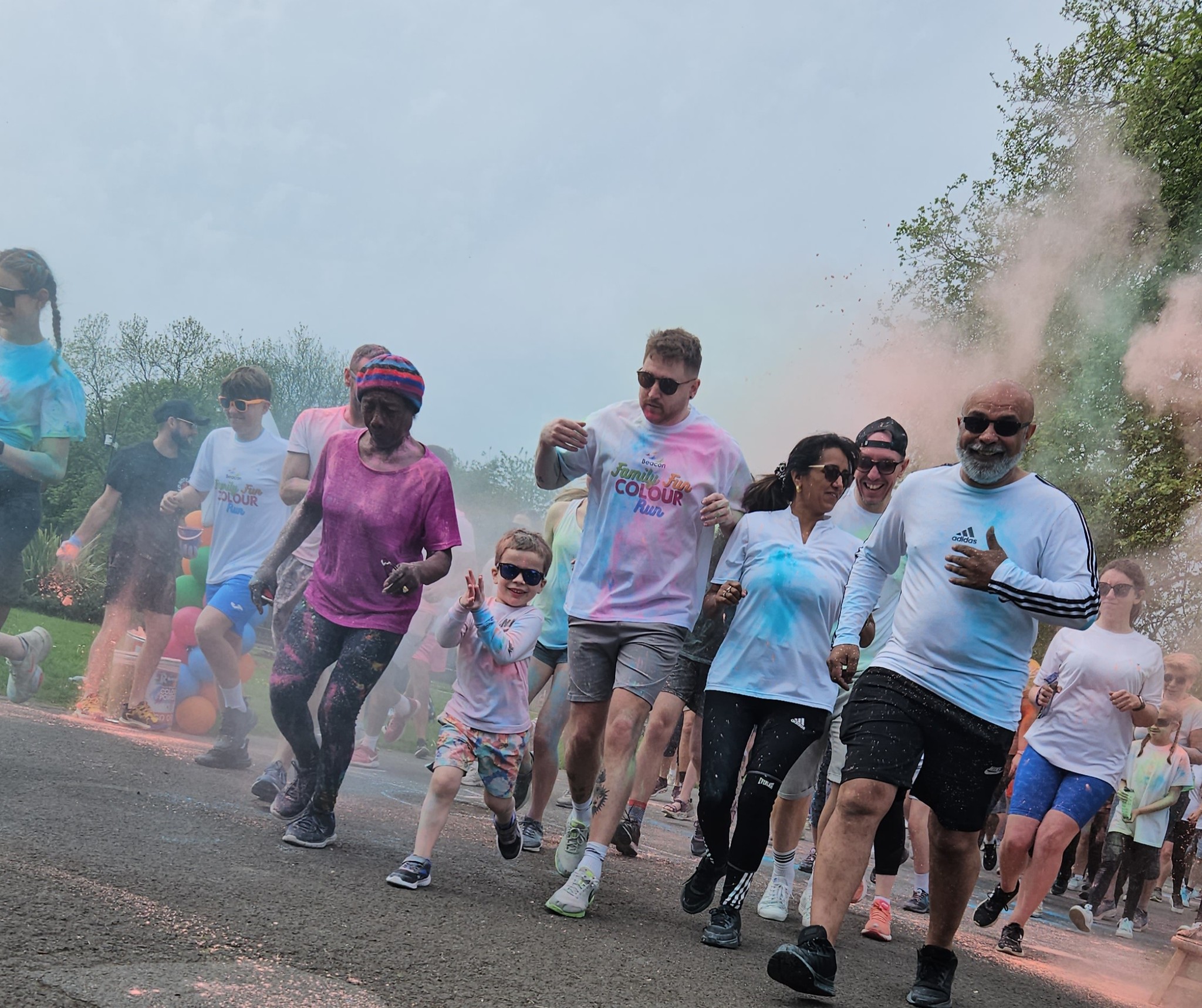 People running through clouds of colour at event 